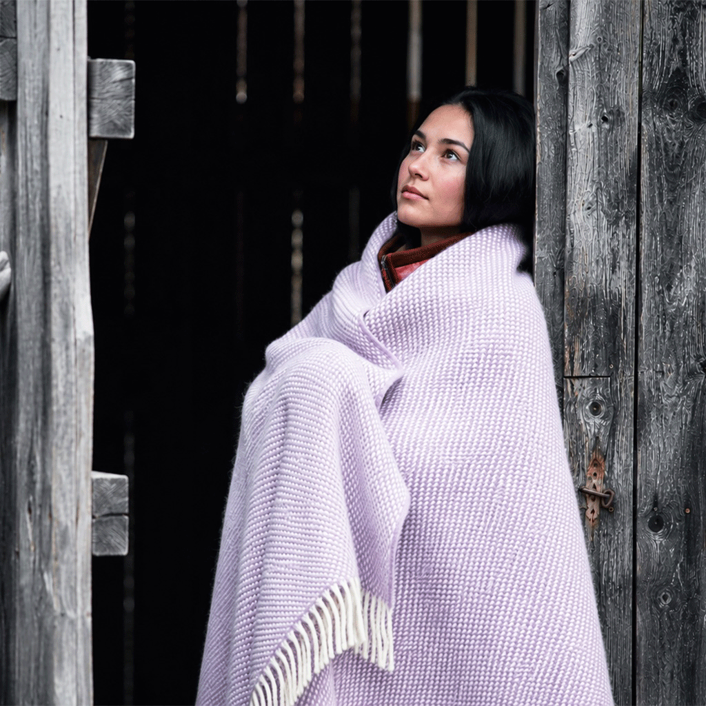 Girl in the doorway with Klippan Preppy lambswool throw