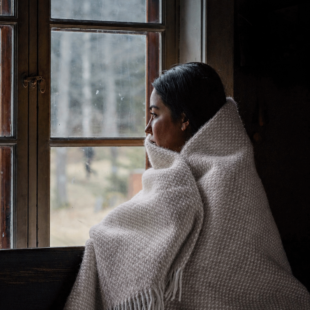 Girlat the window wrapped in Klippan Preppy throw