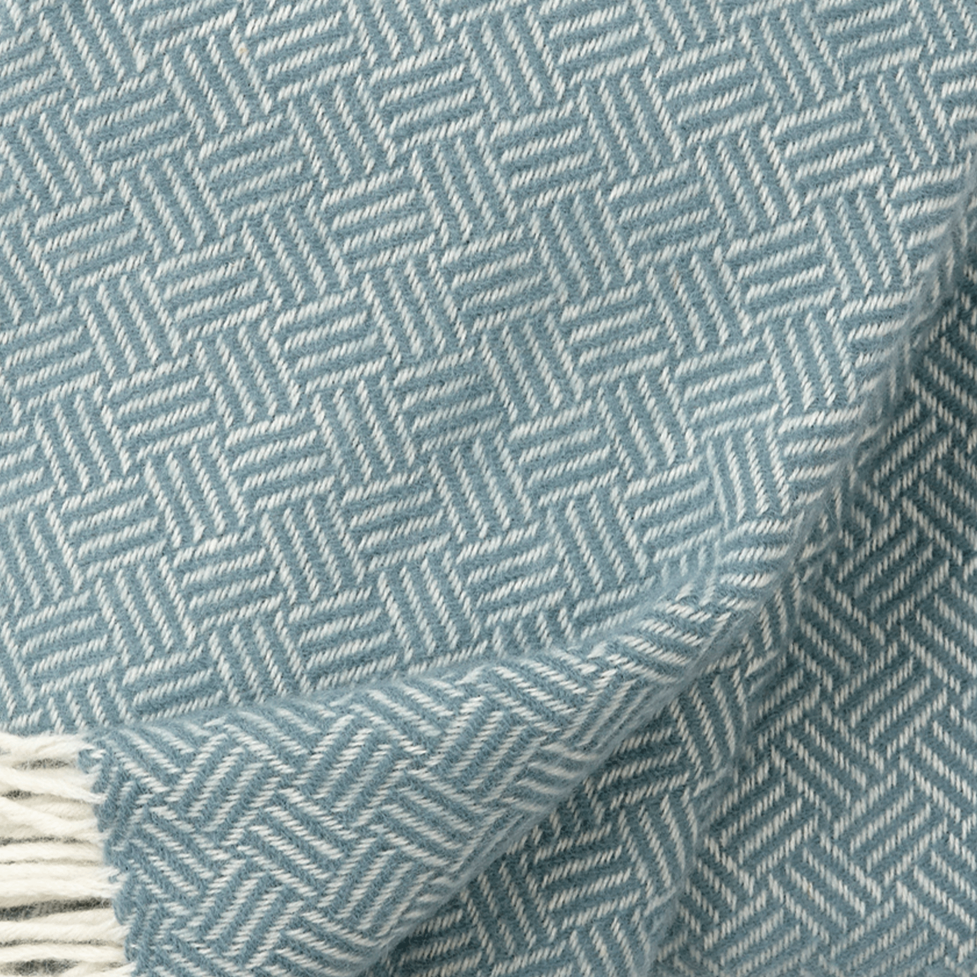 Cose up view of Samba lead grey lambswool throw showing texture and weave