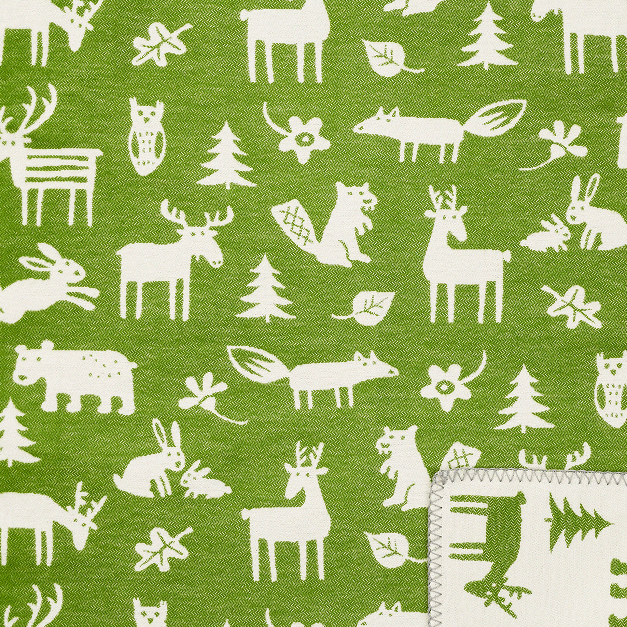 Close up of Klippan's Forest green cotton blanket showing the soft texture