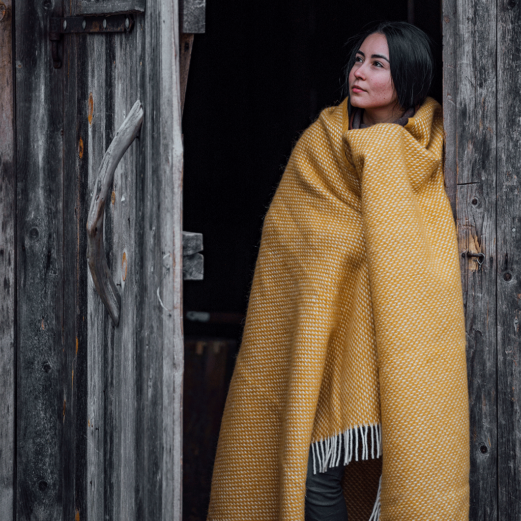 Girl in the doorway with Klippan Preppy mustard yellow lambswool throw