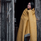 Girl in the doorway with Klippan Preppy mustard yellow lambswool throw