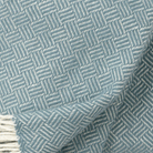 Cose up view of Samba lead grey lambswool throw showing texture and weave