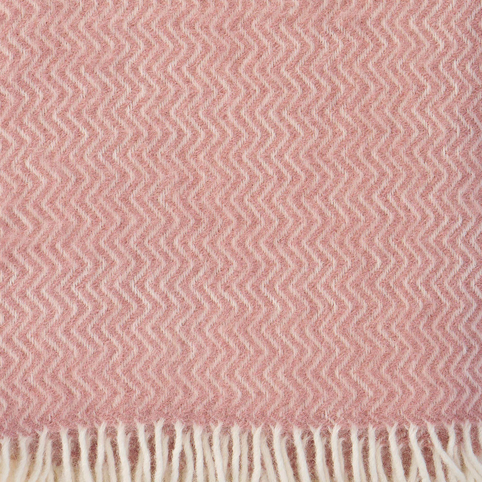 Close up showing texture and weave of Sorbet powder pink lambswool throw from Klippan Homestore