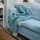 Sorbet Silky Blue throw from Klippan on a blue sofa