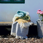 A selection of Klippan Point wool throws on a bench