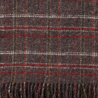 A close up viw of Square red  Brown throw from Klippan showing the texture and weave