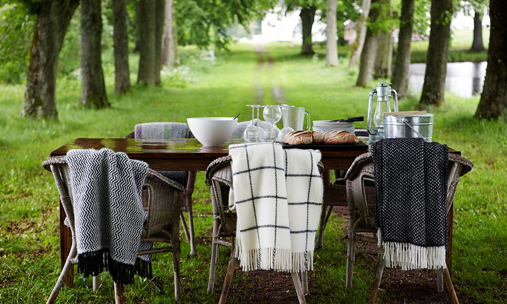 A selection of black and white throws in the garden from Klippan Homestore
