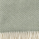 Close p of Klippan Preppy dusty green lambswool throw showing the weave