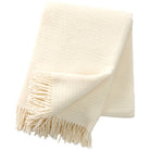 A white eco lambswool throw with a fringed edge, displayed on a neutral background.