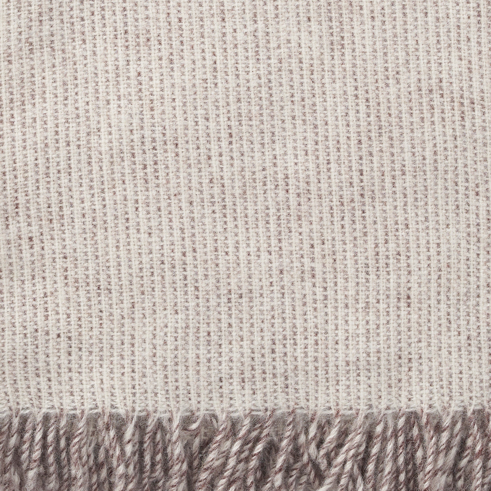 Close up showing the weave and texture of Simmer natural lambswool blanket