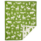 Klippan's Forest green cotton blanket with a white animal pattern, featuring various forest-dwelling creatures such as deer, moose, and pine trees.