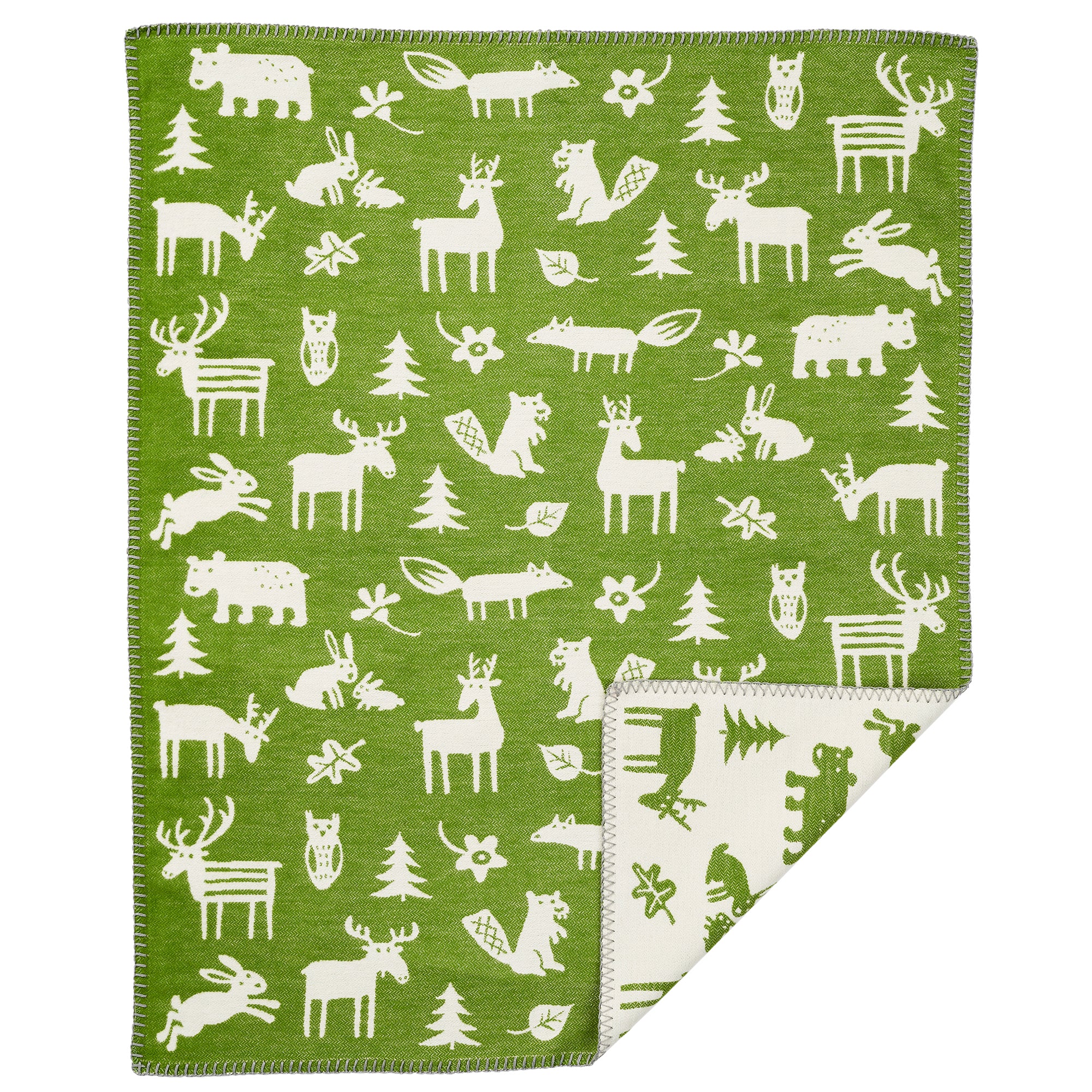 Klippan's Forest green cotton blanket with a white animal pattern, featuring various forest-dwelling creatures such as deer, moose, and pine trees.
